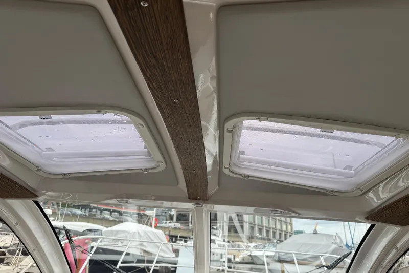  Yacht Photos Pics 2024 Solara S-250 Coupe interior roof with dual skylights and wooden accents.