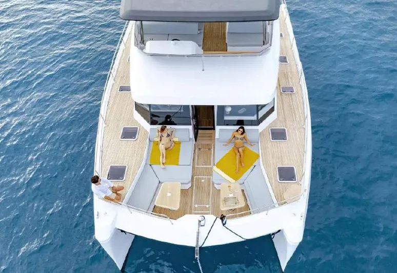  Yacht Photos Pics Aventura 56 Motor Yacht 2025 on blue ocean, featuring spacious deck and lounging area.