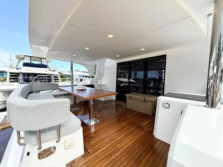  Yacht Photos Pics Luxurious 2025 Aventura 56 Motor Yacht deck with elegant seating and dining area.