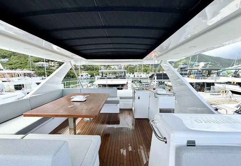  Yacht Photos Pics Luxurious 2025 Aventura 56 Motor Yacht deck with seating and dining area.