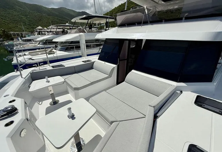 Yacht Photos Pics 2025 Aventura 56 Motor Yacht with sleek seating and modern design in a marina setting.