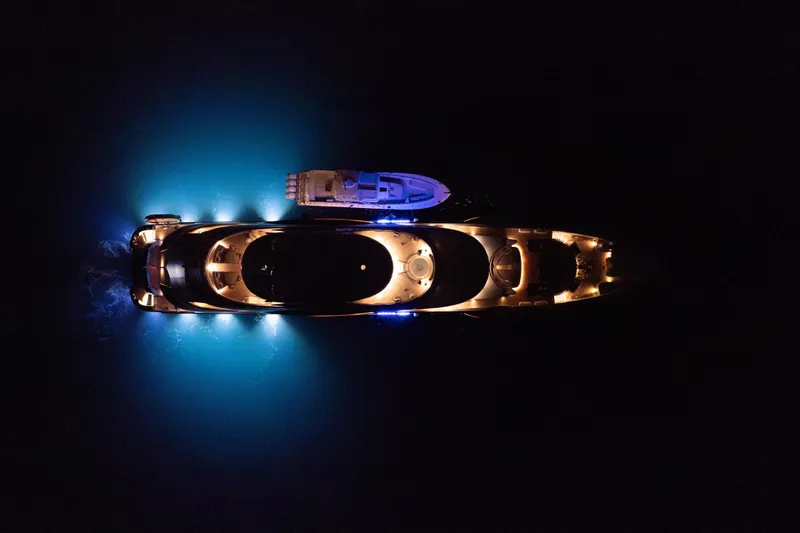 After You Yacht Photos Pics Aerial view of illuminated 2011 Heesen 55m yacht at night, with glowing blue lights.