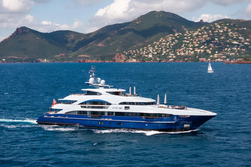 After You Yacht Photos Pics Luxurious 2011 Heesen 55m yacht cruising near scenic coastal mountains.