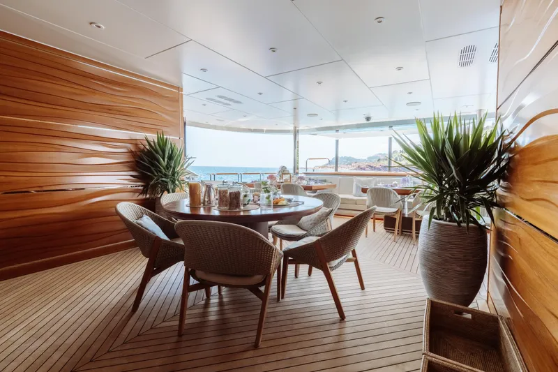 After You Yacht Photos Pics Luxurious Heesen 55m yacht deck with elegant dining area, wooden accents, and ocean view, built in 2011.