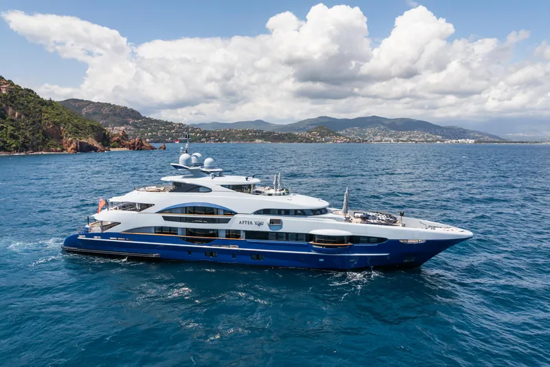 After You Yacht Photos Pics Luxurious 2011 Heesen 55m yacht cruising in scenic coastal waters under a partly cloudy sky.
