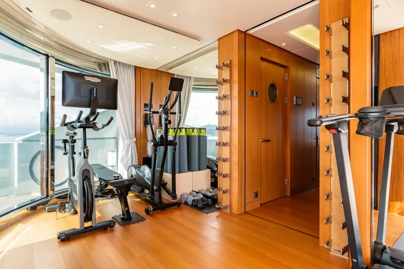 After You Yacht Photos Pics Luxurious gym on 2011 Heesen 55m yacht with exercise equipment and wooden interior.