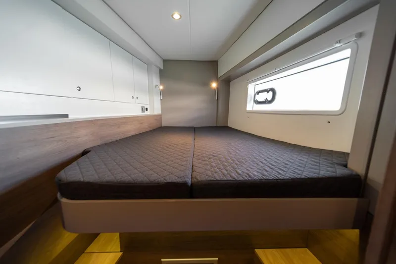 Cat Tales Yacht Photos Pics Modern cabin interior of 2022 Bali 4.2 yacht with cozy bed and window.