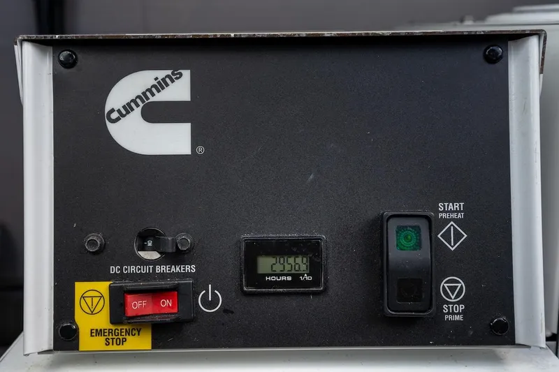 Cat Tales Yacht Photos Pics Control panel of a Cummins generator with emergency stop and circuit breakers.