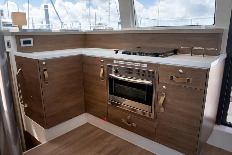 Cat Tales Yacht Photos Pics Modern kitchen interior on 2022 Bali 4.2 yacht with wooden cabinets and built-in oven.