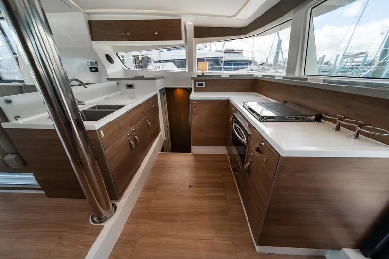Cat Tales Yacht Photos Pics Modern kitchen interior on 2022 Bali 4.2 yacht with wood finish and stainless steel appliances.