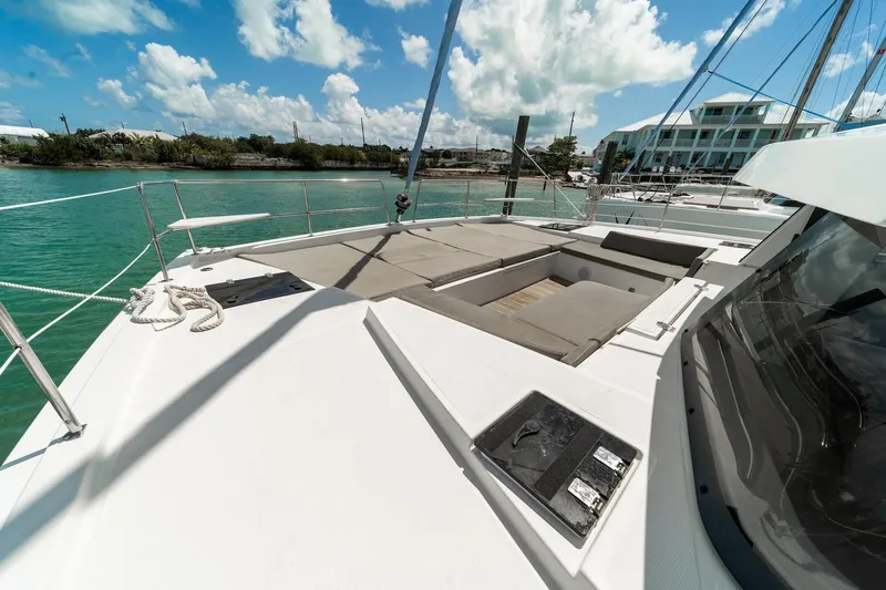 Cat Tales Yacht Photos Pics 2022 Bali 4.2 yacht deck with seating, docked in a sunny marina.