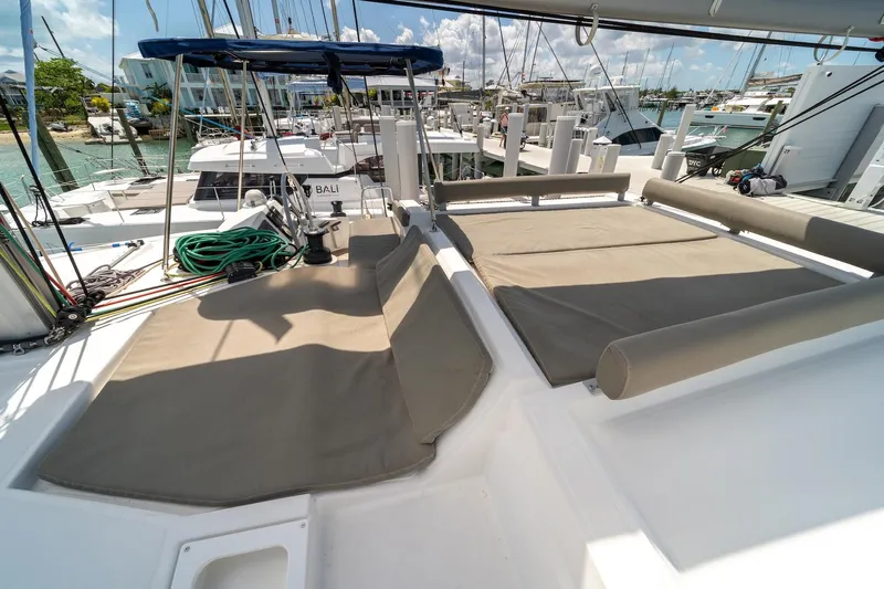 Cat Tales Yacht Photos Pics 2022 Bali 4.2 catamaran with sunbathing area, docked at marina under clear skies.