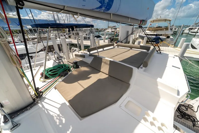 Cat Tales Yacht Photos Pics Bali 4.2 catamaran deck with seating, docked at marina, sunny day, 2022 model.
