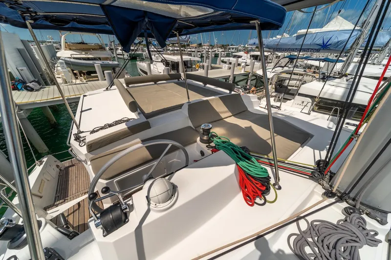 Cat Tales Yacht Photos Pics Bali 4.2 catamaran deck with helm, ropes, and seating, docked at marina, 2022 model.
