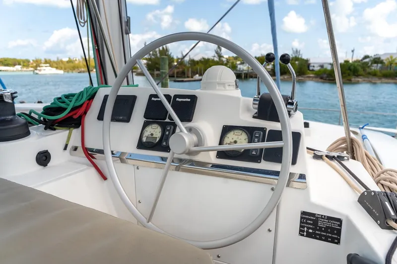 Cat Tales Yacht Photos Pics Steering wheel and controls of a 2022 Bali 4.2 yacht, with ocean view.