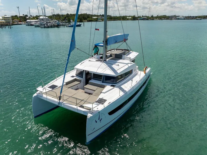 Cat Tales Yacht Photos Pics 2022 Bali 4.2 catamaran sailing on clear turquoise water, sunny day.