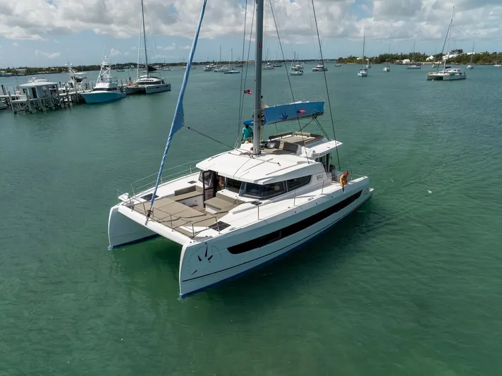 Cat Tales Yacht Photos Pics 2022 Bali 4.2 catamaran sailing in a calm marina with other boats.