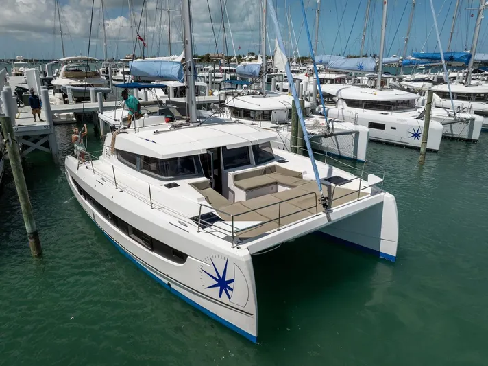 Cat Tales Yacht Photos Pics 2022 Bali 4.2 catamaran docked in marina, surrounded by other boats.