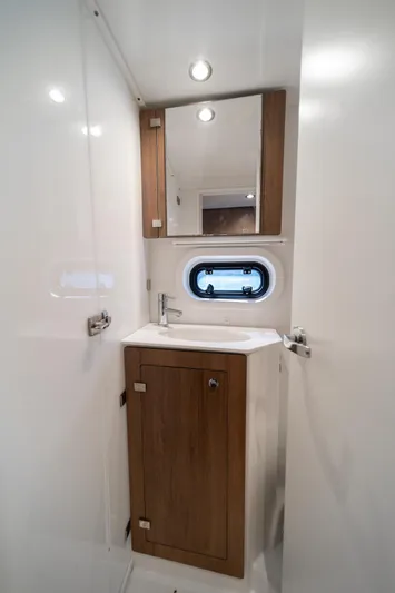 Cat Tales Yacht Photos Pics Modern bathroom interior in 2022 Bali 4.2 yacht with wooden cabinet and porthole window.