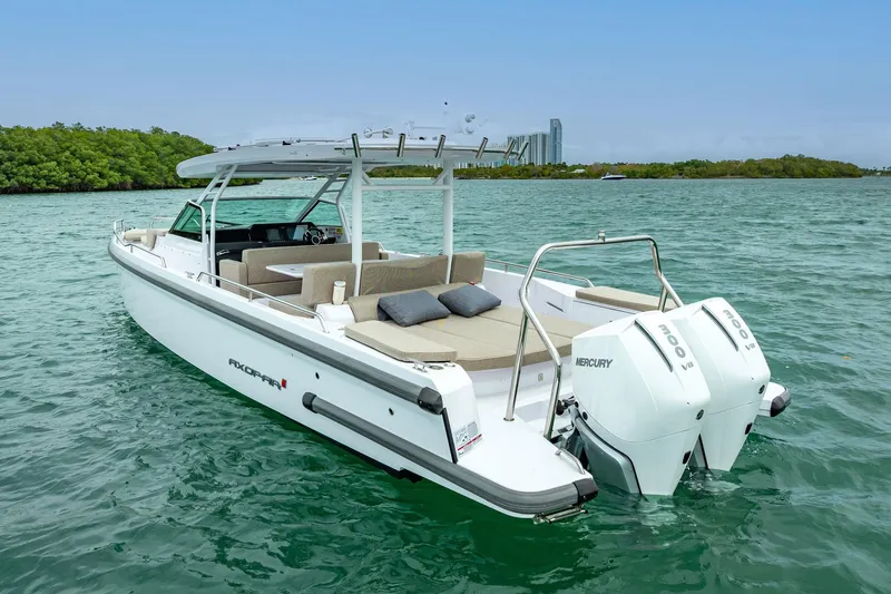  Yacht Photos Pics 2024 Axopar 37 Sun-Top boat with twin Mercury engines on turquoise water.