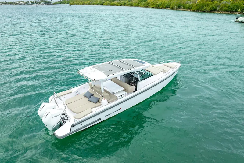  Yacht Photos Pics 2024 Axopar 37 Sun-Top boat cruising on clear turquoise water.