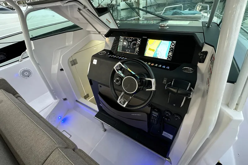  Yacht Photos Pics 2024 Axopar 37 Sun-Top helm with modern navigation displays and sleek steering wheel.
