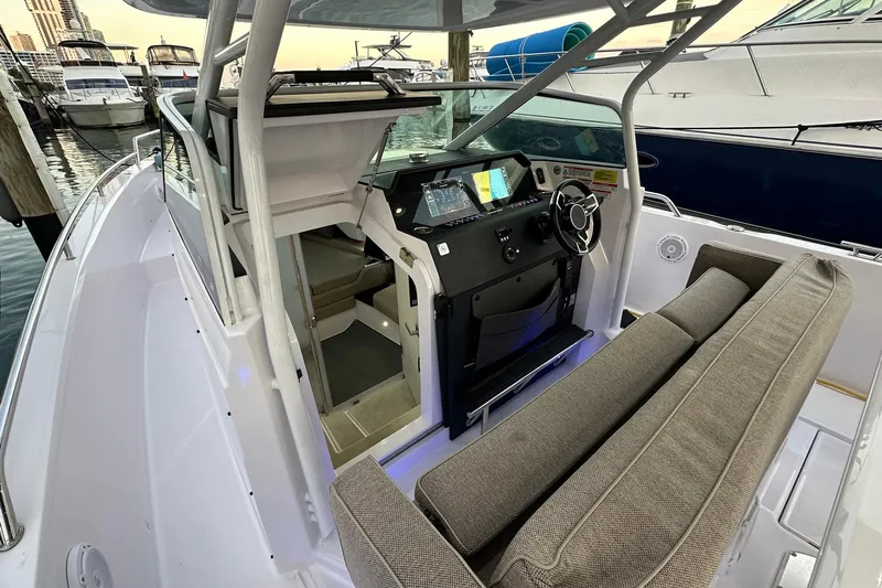  Yacht Photos Pics 2024 Axopar 37 Sun-Top boat interior with helm, seating, and modern controls.