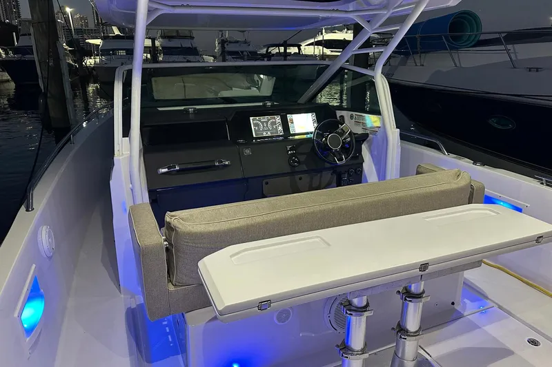  Yacht Photos Pics 2024 Axopar 37 Sun-Top boat interior with illuminated dashboard and seating area.