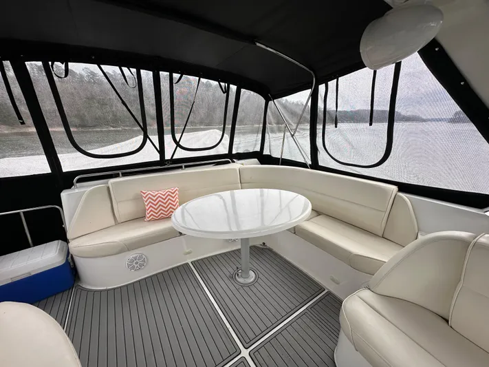  Yacht Photos Pics Interior seating area of 2001 Carver 570 Voyager Pilothouse yacht with round table.