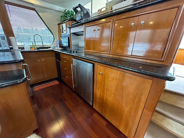  Yacht Photos Pics Luxurious kitchen area in a 2001 Carver 570 Voyager Pilothouse yacht with wooden cabinetry.