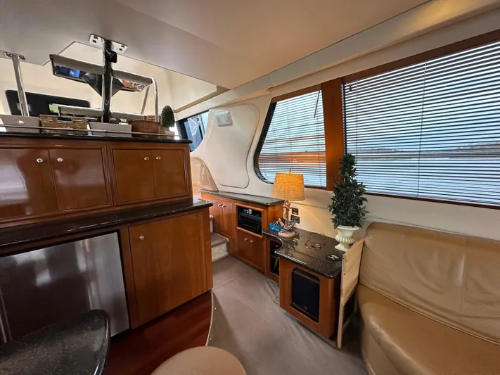  Yacht Photos Pics Interior of 2001 Carver 570 Voyager Pilothouse with wooden cabinetry and leather seating.