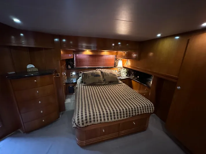  Yacht Photos Pics Luxurious bedroom interior of 2001 Carver 570 Voyager Pilothouse yacht with wooden cabinetry.