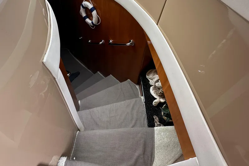  Yacht Photos Pics Staircase inside 2001 Carver 570 Voyager Pilothouse yacht with carpeted steps and wooden walls.