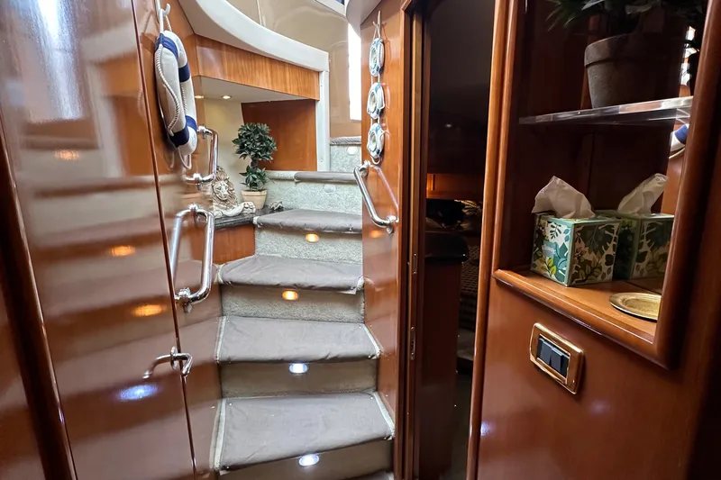  Yacht Photos Pics Interior stairs of 2001 Carver 570 Voyager Pilothouse yacht with wooden finish.