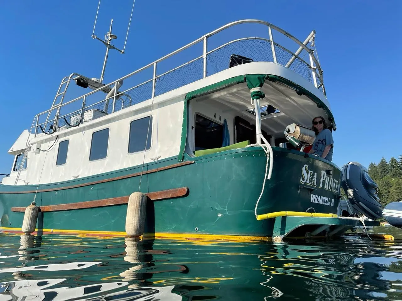 Custom 2010 Trawler "Sea Prince" on water, green and white exterior, sunny day.