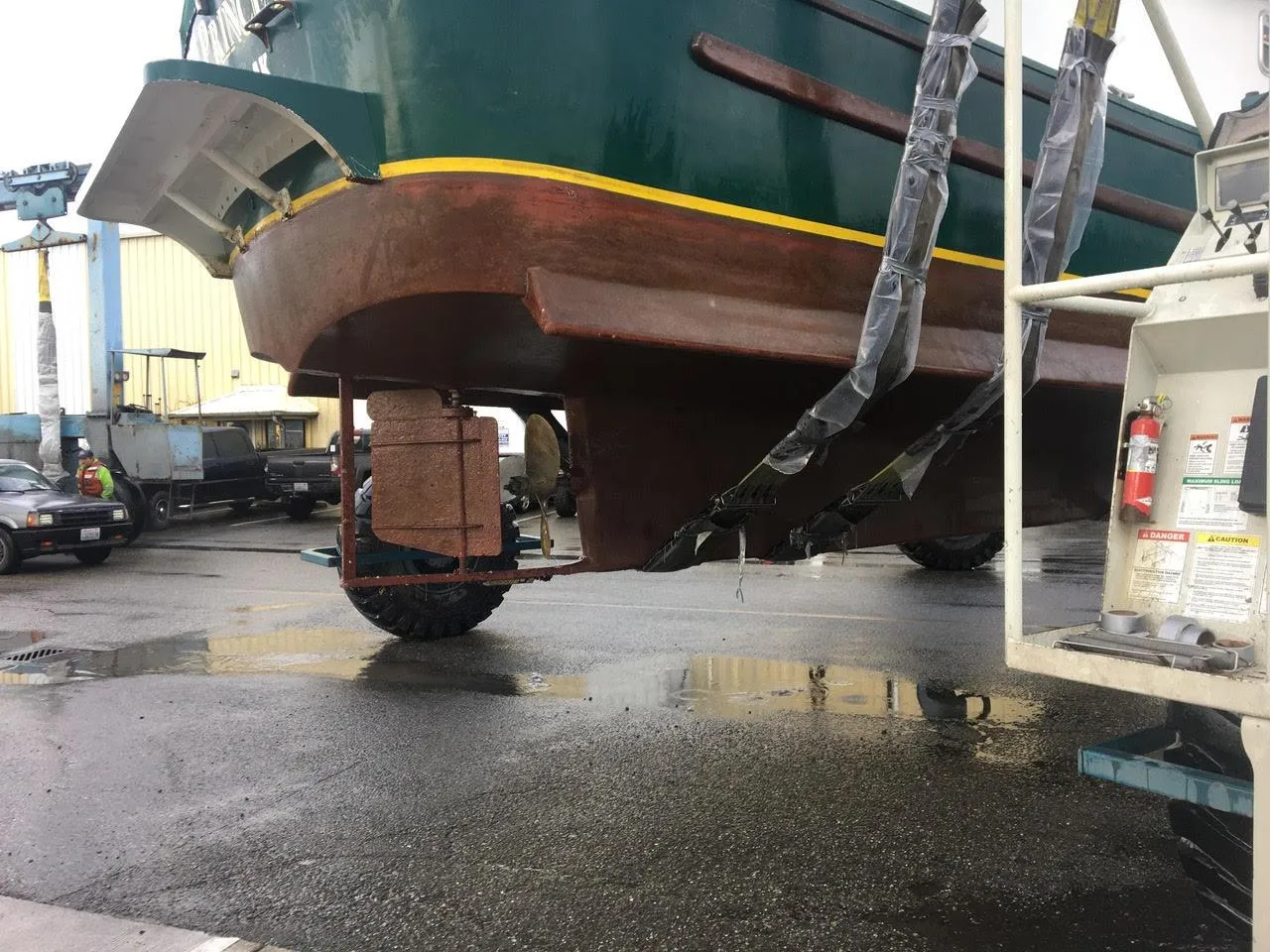 Custom 2010 trawler being lifted for maintenance in a shipyard.