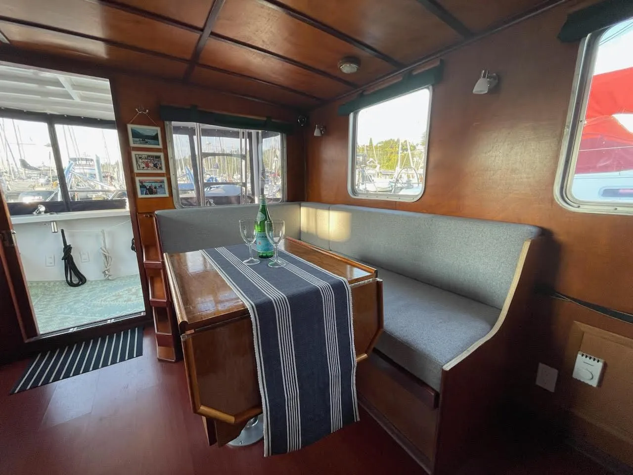 Interior of a 2010 custom trawler with wooden finishes and cozy seating area.