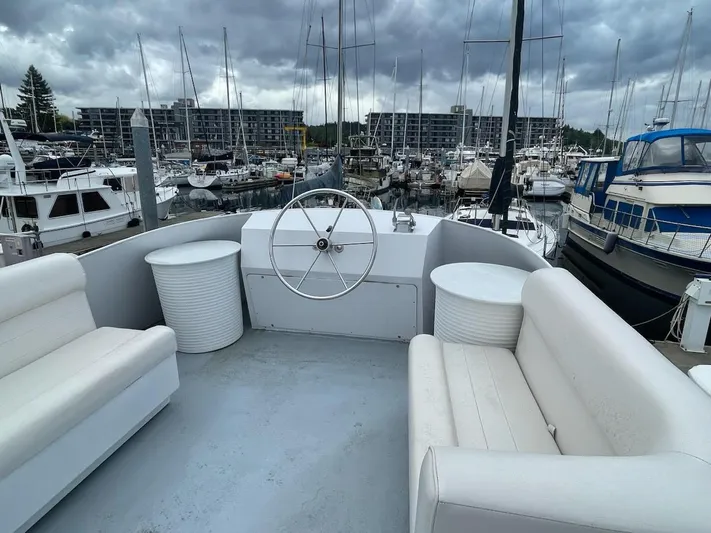 Sea Prince III Yacht Photos Pics Custom 2010 trawler with white seating, docked in a marina under cloudy skies.