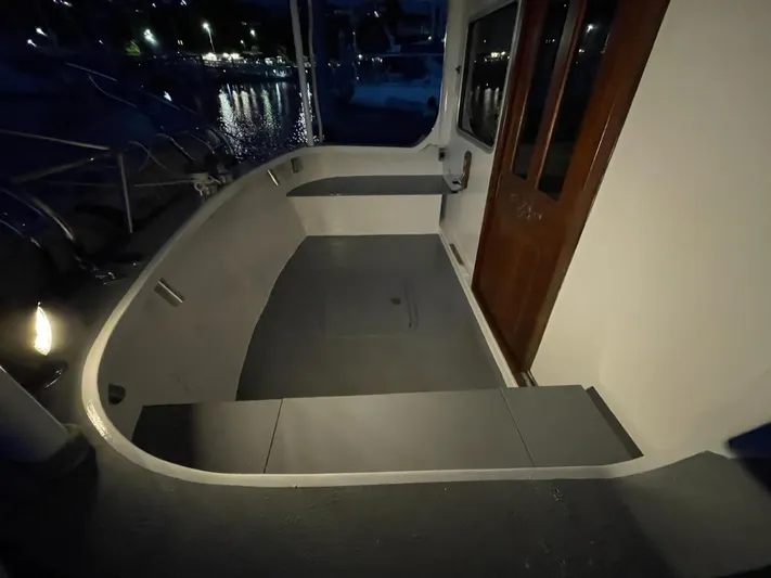 Sea Prince III Yacht Photos Pics Custom 2010 Trawler deck at night, featuring wooden door and ambient lighting.