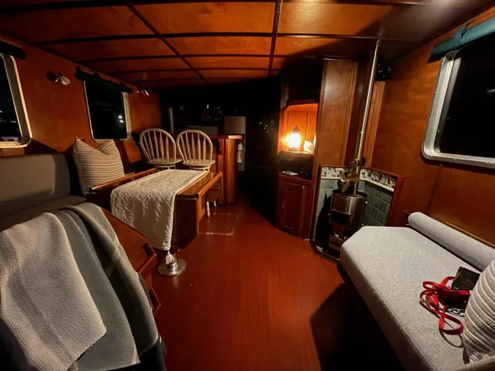 Sea Prince III Yacht Photos Pics Cozy interior of a 2010 custom trawler with wooden furnishings and ambient lighting.