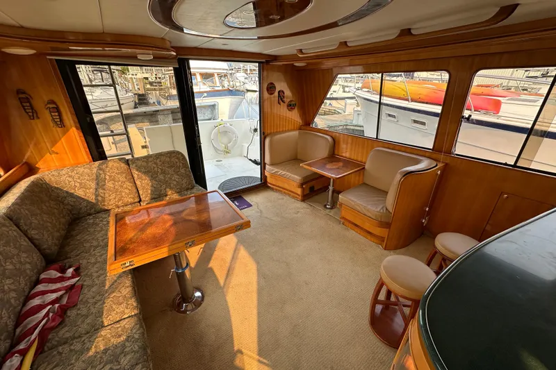 Sunchaser Yacht Photos Pics Luxurious interior of a 1999 Hampton 490 yacht with elegant seating and wooden accents.