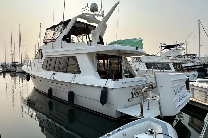 Sunchaser Yacht Photos Pics 1999 Hampton 490 yacht docked in a marina, surrounded by other boats.
