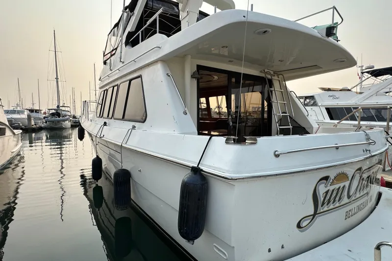 Sunchaser Yacht Photos Pics Luxury 1999 Hampton 490 yacht docked in marina, featuring sleek design and spacious deck.