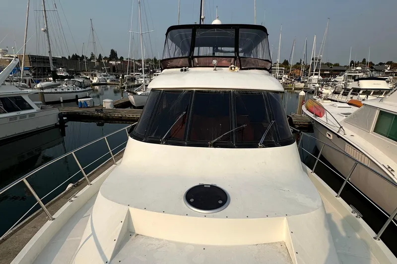 Sunchaser Yacht Photos Pics 1999 Hampton 490 yacht docked in a marina, surrounded by other boats.