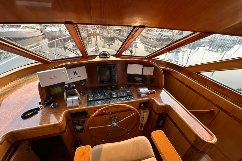 Sunchaser Yacht Photos Pics Interior helm of 1999 Hampton 490 yacht with wooden dashboard and navigation equipment.