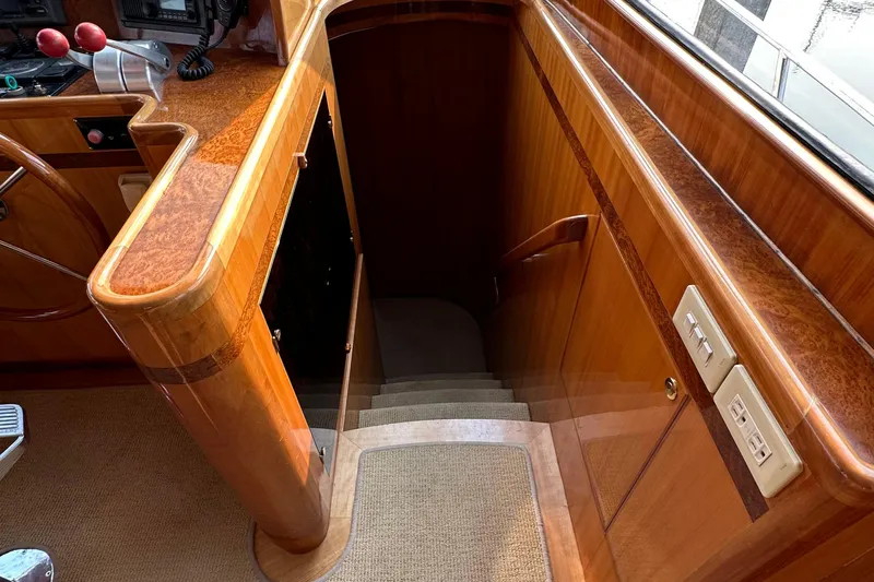 Sunchaser Yacht Photos Pics Interior of 1999 Hampton 490 yacht with polished wood and carpeted stairs.