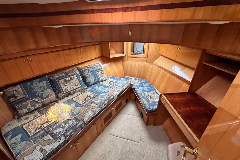 Sunchaser Yacht Photos Pics Luxurious cabin interior of a 1999 Hampton 490 yacht with wooden finish and patterned cushions.