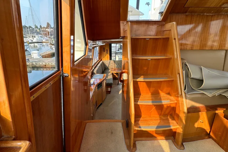 Sunchaser Yacht Photos Pics Interior of a 1999 Hampton 490 yacht with wooden stairs and seating area.