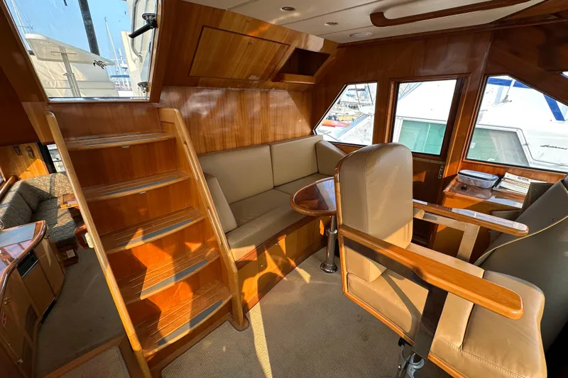 Sunchaser Yacht Photos Pics Luxurious 1999 Hampton 490 yacht interior with wooden finishes and comfortable seating.