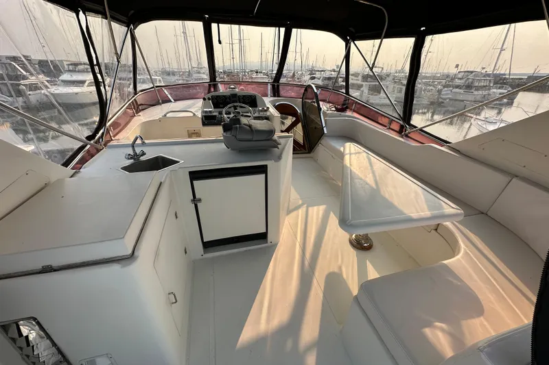 Sunchaser Yacht Photos Pics Interior view of 1999 Hampton 490 yacht with seating, helm, and kitchenette.